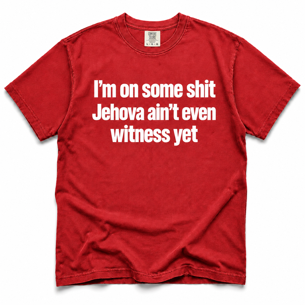 A red short-sleeve crewneck t-shirt with bold white text on the front reading 'I'm on some shit Jehovah ain't even witness yet', displayed flat against a white background.