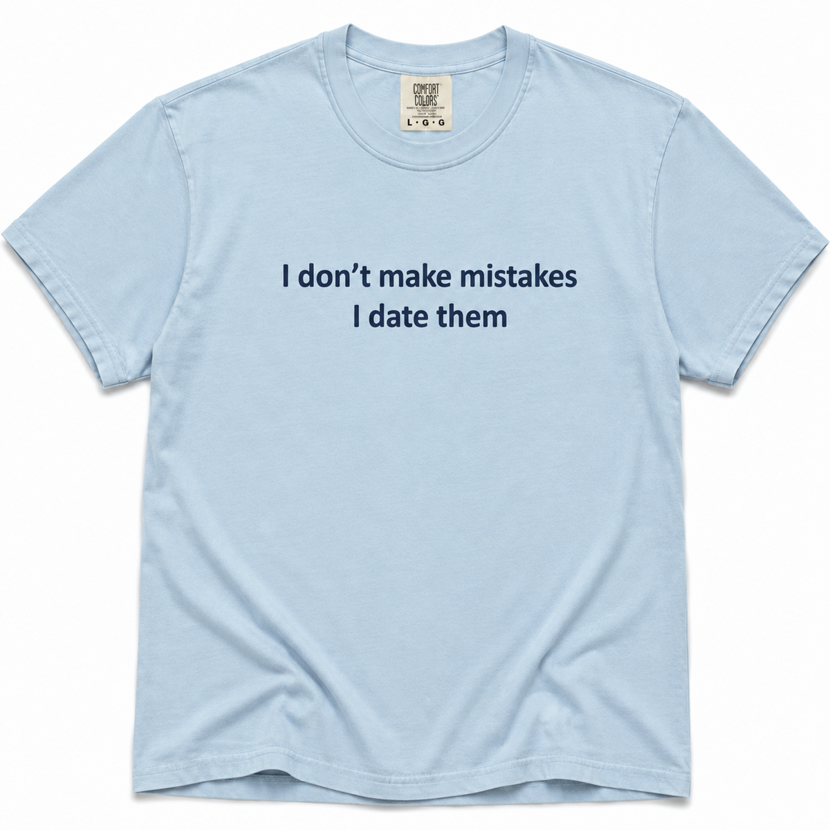 Chambray short-sleeve crewneck T-shirt with dark navy “I Don’t Make Mistakes, I Date Them” text printed across the chest on a white background.