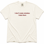 Ivory short-sleeve crewneck T-shirt with dark red “I Don’t Make Mistakes, I Date Them” text printed across the chest.