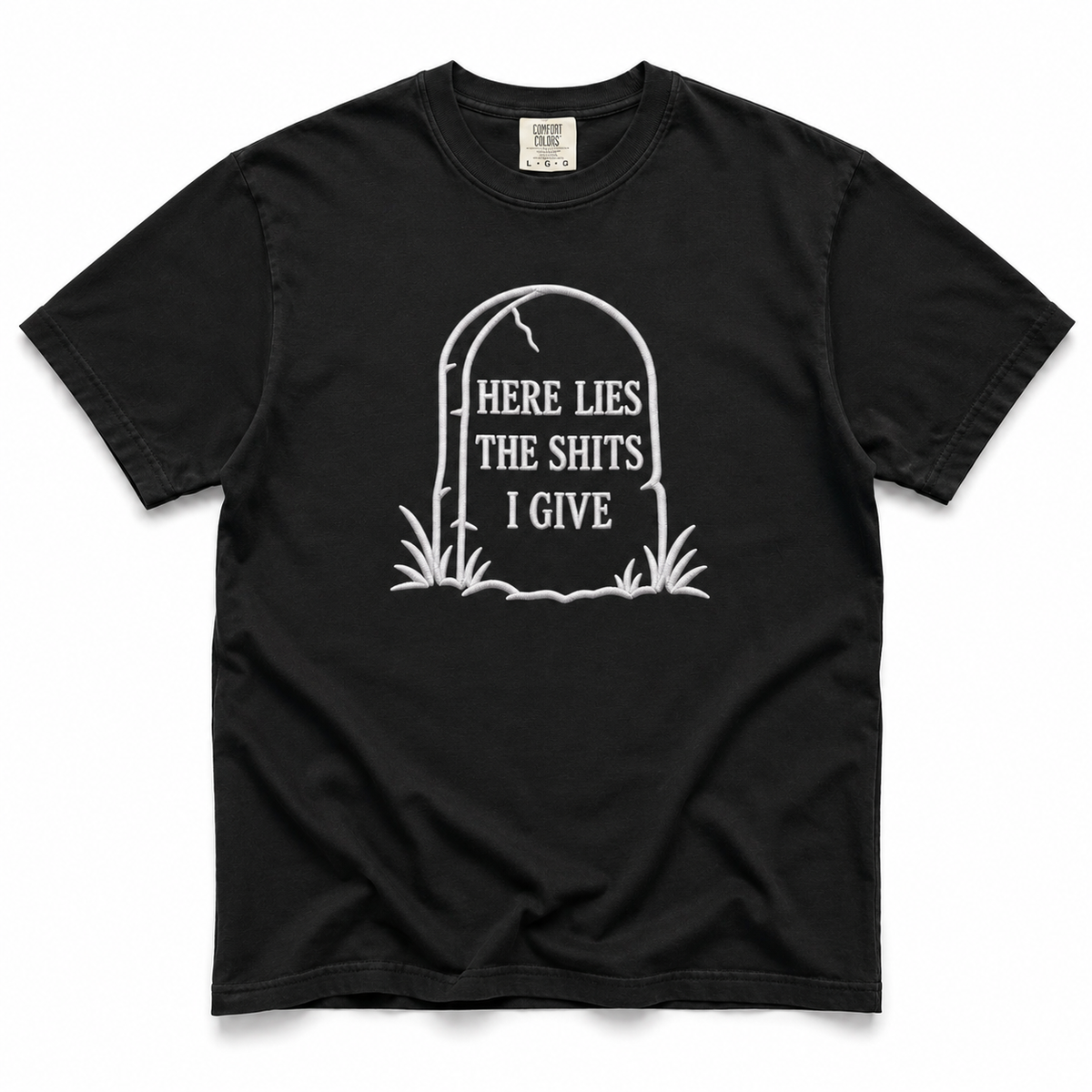 A black short-sleeve crewneck t-shirt with a white graphic of a tombstone that reads 'HERE LIES THE SHITS I GIVE' on a plain white background.
