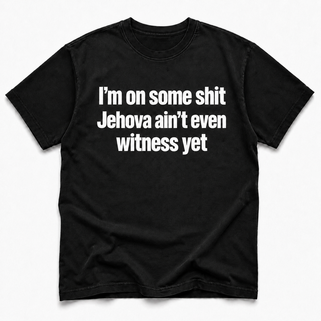A black short-sleeve crewneck t-shirt with bold white text on the front reading 'I'm on some shit Jehovah ain't even witness yet', displayed flat against a light gray background.