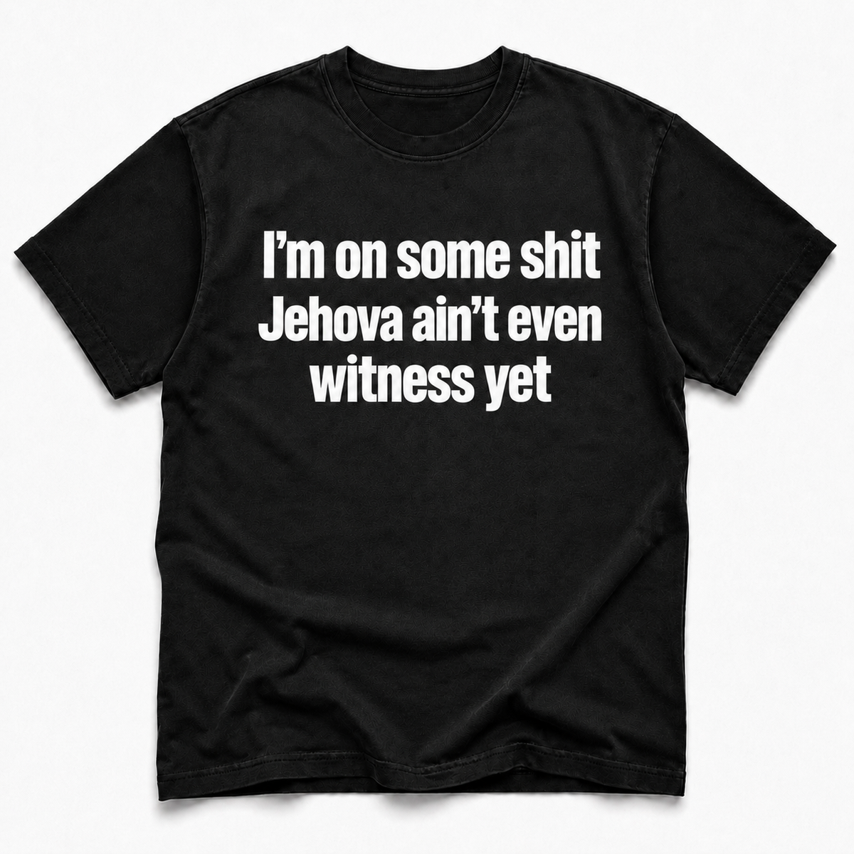 A black short-sleeve crewneck t-shirt with bold white text on the front reading 'I'm on some shit Jehovah ain't even witness yet', displayed flat against a light gray background.