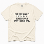 ivory crewneck t-shirt with black text on the chest that reads 'DARK HUMOR IS LIKE A DAD. SOME PEOPLE DON'T HAVE ONE.
