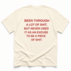 ivory short-sleeve t-shirt with bold red text printed on the back, laid flat against a clean white background.