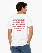 A man wearing a white t-shirt with bold red text on the back, shown from behind against a plain white background.